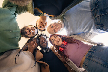 Plakat young multicultural students looking down smiling in circle friendship and community concept
