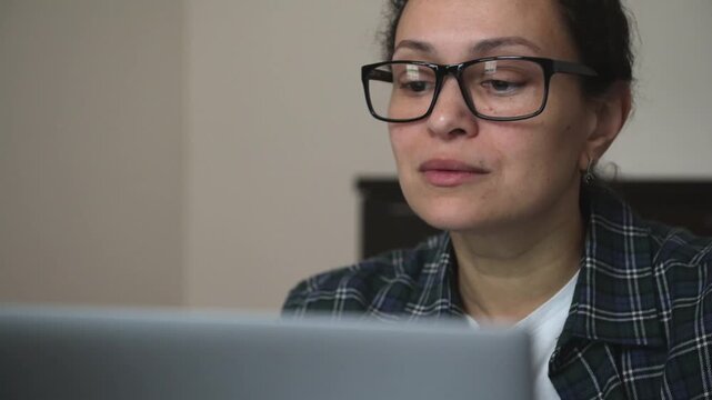 Focused Woman Working on Laptop at Home