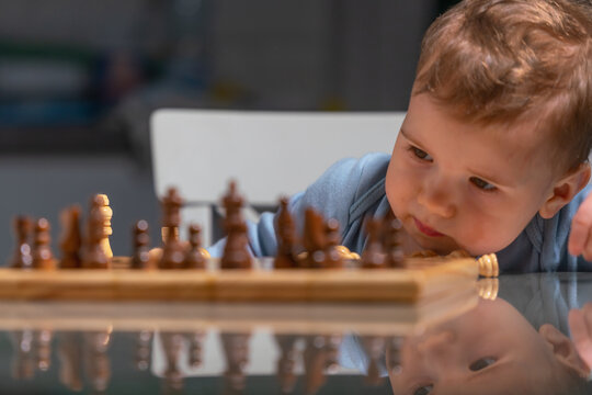Future grandmaster carefully considering the fate of every chess piece.