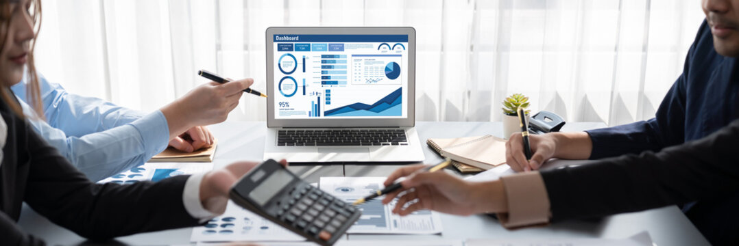 Business intelligence and data analysis concept. Analyst team working on financial data analysis dashboard on laptop screen as marketing indication for effective business strategic planning. Insight