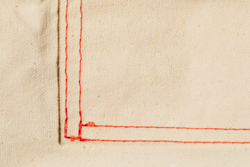 red stitching on cotton canvas