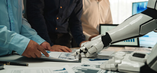 A futuristic scene showcasing a robotic hand collaborating with business professionals in a modern...