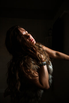 Profile of a woman in a fur vest