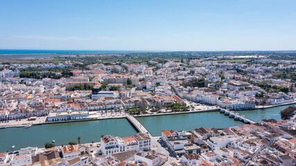 Tavira in Algarve is seen from above with traditional buildings lined along the Gilao river. The...
