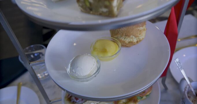 Slow motion steady cam down tower of plates with delicious snacks