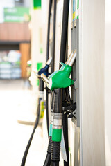 Gasoline pump nozzle with hose for automotive refueling