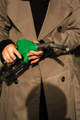 Hand gripping gasoline nozzle at service station © Rabizo Anatolii