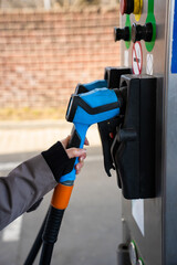 Hand holding gas pump nozzle during LPG car refueling © Rabizo Anatolii