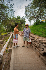 Couple holding hands walking park for picnic