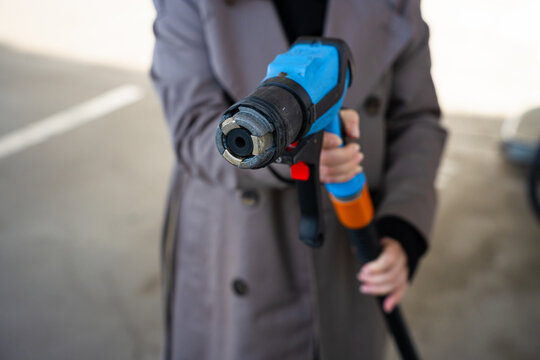 Close-up of LPG fuel nozzle in car tank during refueling