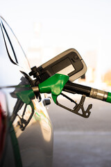 Fuel pump inserted into tank during refueling. Close-up refilling vehicle with gasoline © Rabizo Anatolii