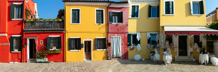 Burano Venice traditional lace shop on colorful street with red and yellow house facades Italy island artisan craft souvenir boutique handmade merletto 12k high resolution panorama