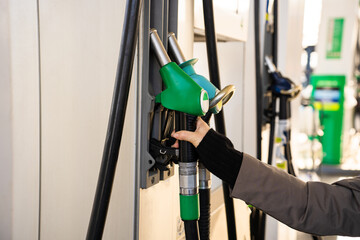 Vehicle refueled using gasoline pump nozzle at station © Rabizo Anatolii