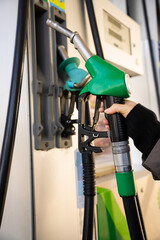 Close-up of gasoline nozzle filling car fuel tank © Rabizo Anatolii