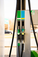 Petrol pump nozzles at service station. Fuel pump nozzles at gasoline station