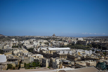 Naklejka premium Panoramic View of Gozo’s Urban Landscape with Rotunda of Xewkija in the Distance, Malta