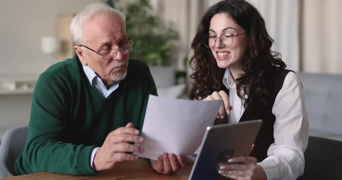 Senior man reviewing agreement, examining condition of insurance or financial papers during consultation with advisor, people handshaking, finalize decision, confirming terms of service contract. Deal