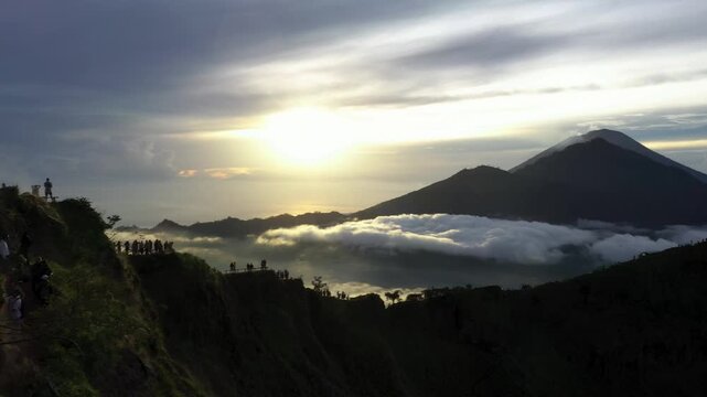 Bali, Indonesia &ndash; Sunrise at Mount Batur Summit with Volcanic Steam, Visitors, and Mount Abang in the Distance