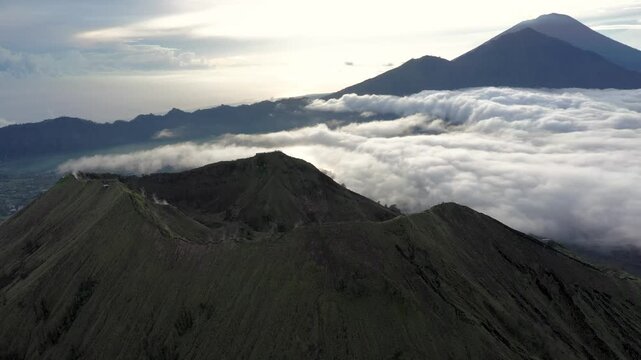 Bali, Indonesia &ndash; Sunrise Drone View of Mount Batur with Cloud Inversion and Mount Abang in the Distance