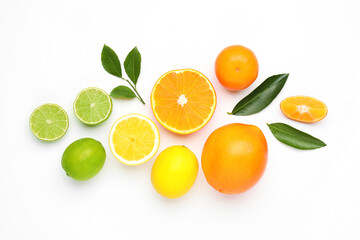 Fototapeta premium Different fresh citrus fruits and green leaves on white background, flat lay