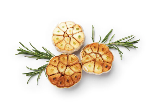 Grilled garlic bulbs with rosemary isolated on white, top view