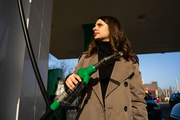 Driver filling automobile with gasoline using fuel station nozzle © Rabizo Anatolii