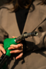 Hand holding gasoline nozzle at fuel station close-up. Driver refueling car using gasoline pump © Rabizo Anatolii