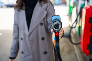 Hand holding LPG pump nozzle refueling car at gas station © Rabizo Anatolii