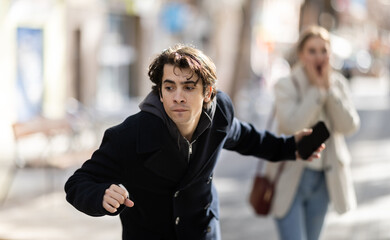 Moment of attack on passerby, robbed girl lost her phone, screams in horror. Thief runs away from...