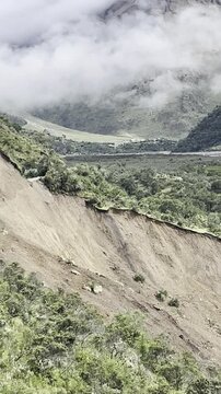 A fresh landslide covers a steep mountain trail on the route to Machu Picchu, illustrating how falling rocks and mud can isolate hikers in the remote Andes. Filmed in Peru.