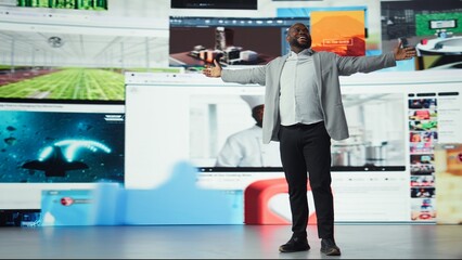 Ecstatic viewer celebrating freedom of unlimited video content in virtual space. Delighted african...