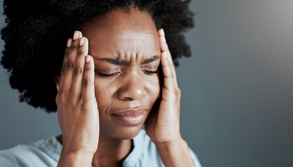 Fototapeta premium Woman with a headache holds her head with both hands. Suitable for medical, mental health, stress and headache related concepts, websites, and designs.