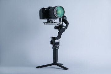 Gimbal stabilizer with camera on light background © New Africa