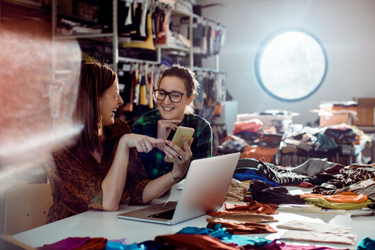 Two fashion designers collaborating in textile studio