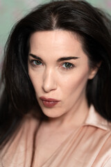 Obraz premium Editorial Portrait of Attractive Woman with Green Eyes and Dark Brown Hair