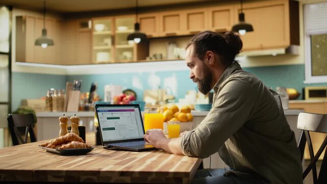 Man using laptop to verify tracking number and shipment route details for a delayed order package, courier service issues highlighting modern e-commerce. Package tracking with real time updates.