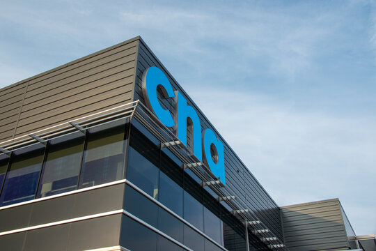 St. John's, Newfoundland, Canada-March 17, 2026: The exterior corner of the College of the North Atlantic building with a bright blue sign. The letters cna are lit up bright blue.
