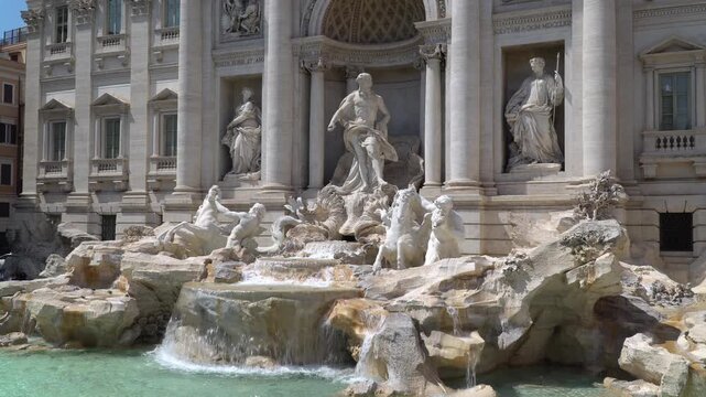 Sculptures of Sea god Oceanus and tritons in white marble at the Trevi fountain located in the heart of the historic city, Rome, Italy. 