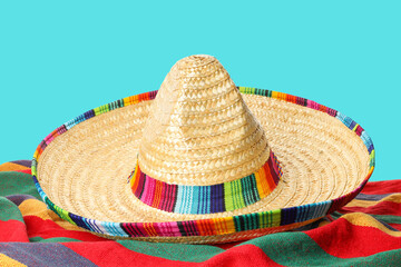 Obraz premium Cinco de Mayo, A sombrero lies on a colorful striped blanket