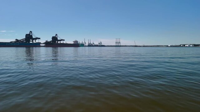 Aerial view of shipping containers and industrial port cranes on the Elizabeth River in Norfolk Virginia waterfront