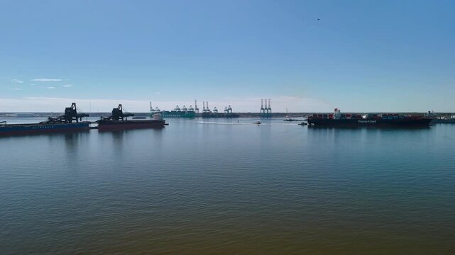Aerial view of shipping containers and industrial port cranes on the Elizabeth River in Norfolk Virginia waterfront