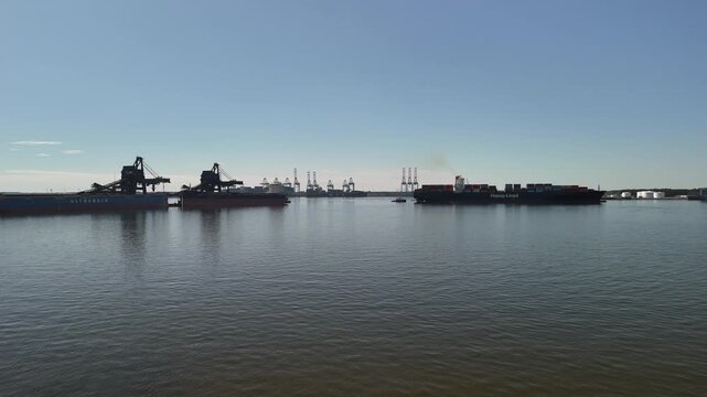 Aerial view of shipping containers and industrial port cranes on the Elizabeth River in Norfolk Virginia waterfront