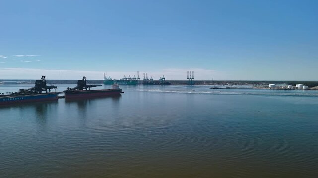 Aerial view of shipping containers and industrial port cranes on the Elizabeth River in Norfolk Virginia waterfront