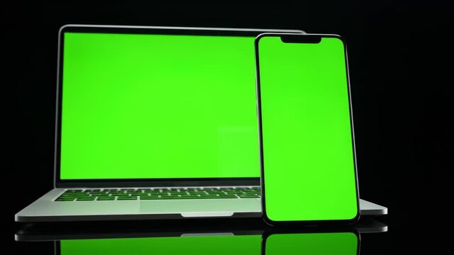 Set of laptop phone with green screen, on black background.