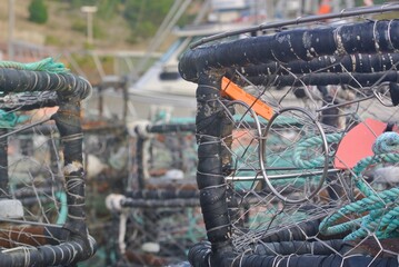 Commercial crab pots piled together with marine rope and floats  © Susan