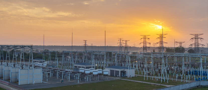 Electrical Substation at Sunset with Power Lines and Transformers
