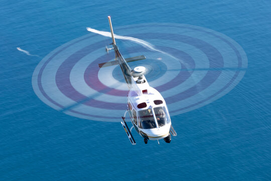Helicopter (Eurocopter AS350)  over the Pacific ocean at very low shutter speed