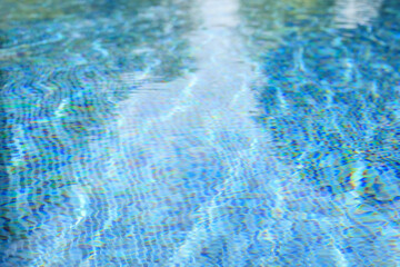 Obraz premium Swimming pool with blue crystal clear water surface and ripple wave background