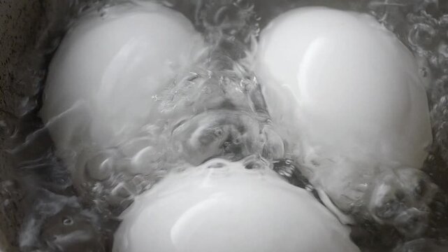Hard boiling eggs in a pot of water on the stove