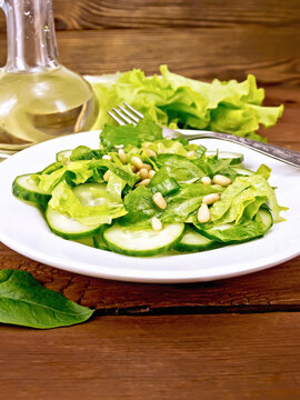 Salad from spinach and cucumber with lettuce on board